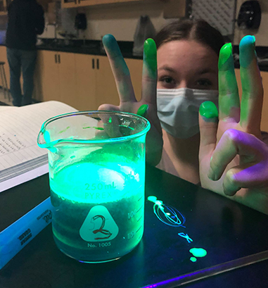 Student doing glow in the dark science