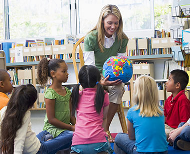 Teacher showing students a globe